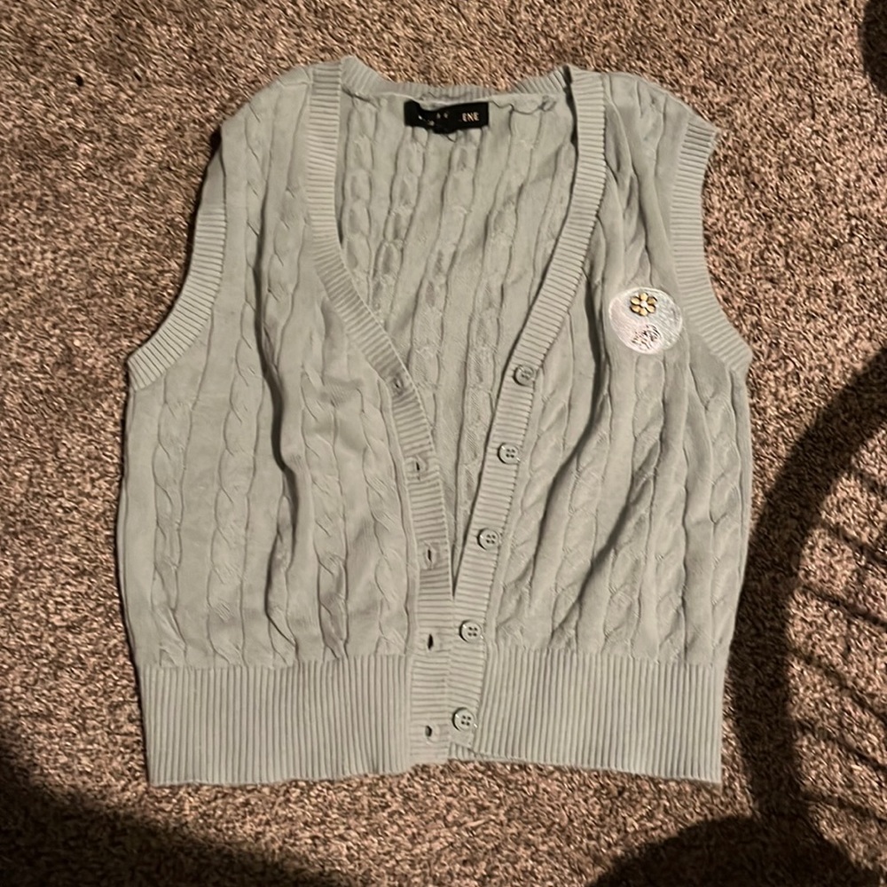 This a cute button up vest in a nice shade of green.